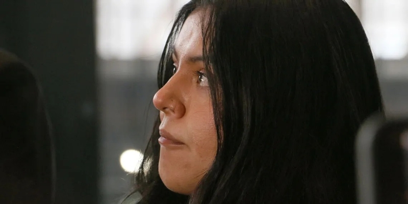 Marimar Martinez looks at her attorney with tears in her eyes as he speaks to press about the lingering impact the shooting has had on her after a Feb. 6, 2026, hearing to modify the protective order sealing evidence in her case. (Capitol News Illinois photo by Maggie Dougherty)