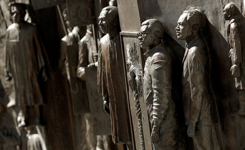 A detailed view of the African American History Monument outside the South Carolina Statehouse in Columbia, South Carolina, which was dedicated in 2001. The monument does not identify anyone, but South Carolinians easily identifiable in the panels' sculptures include former state Chief Justice Ernest Finney Jr., astronaut Ronald McNair, the Rev. Jesse Jackson, and boxer Joe Frazier. (Photo by Travis Bell/SIDELINE CAROLINA/Special to the SC Daily Gazette)