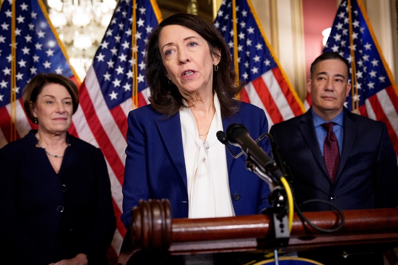 Sen. Maria Cantwell, D-Wash., center, speaks during a news conference at the U.S. Capitol Building on Feb. 24, 2026 in Washington, D.C.  At left is Sen. Amy Klobuchar, D-Minn., and at right is Washington Secretary of State Steve Hobbs. (Photo by Andrew Harnik/Getty Images)