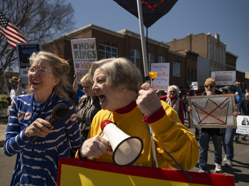 Amy Deputy, left, and Claudia Haynes, both of Bowling Green, share a microphone as they march on Park Row in Bowling Green, Kentucky, during a No Kings protest on Saturday, March 28, 2026. (Photo by Austin Anthony for the Kentucky Lantern)