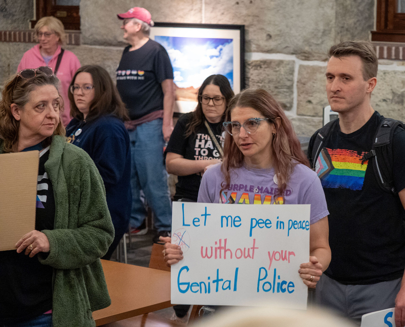 A group of trans activists pose for pictures on Feb. 6, 2026, at the Kansas Statehouse, advocating against a bathroom bill that eventually passed. A similar law went into effect in Texas Dec. 4 and has caused universities, city and other government entities to make changes. (Photo by Sherman Smith/Kansas Reflector)