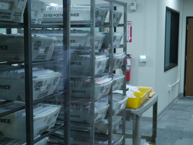 Baskets of ballots sit at a new ballot processing center in Thurston County, Washington. (Photo by Jake Goldstein-Street/Washington State Standard)