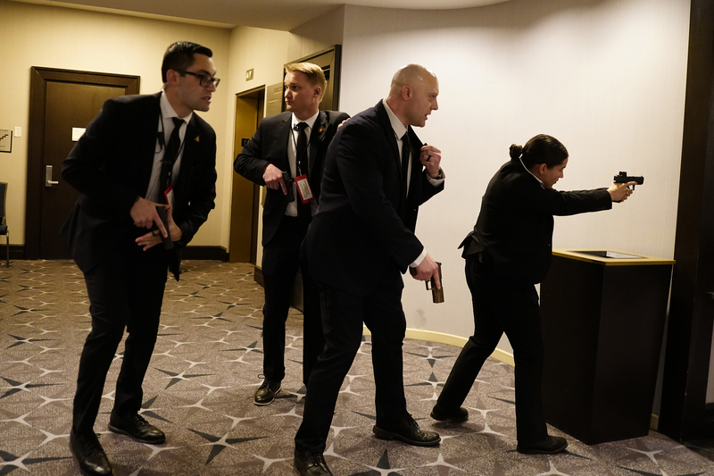 Federal agents draw their guns out after an incident at the annual White House Correspondents Association Dinner April 25, 2026 in Washington, DC. According to reports, President Donald Trump, along with other government officials, were evacuated from the Washington Hilton after what sounded like gun fire. (Photo by Nathan Howard/Getty Images)