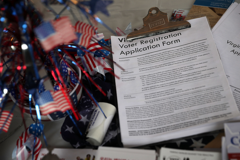 A pile of voter registration forms is seen at the booth of Fairfax County Republican Committee during the annual KORUS festival, a Korean cultural festival, October 1, 2016 in Tysons Corner, Virginia. It has been reported that the voter registration systems of more than 20 states were targeted by hackers in recent months.