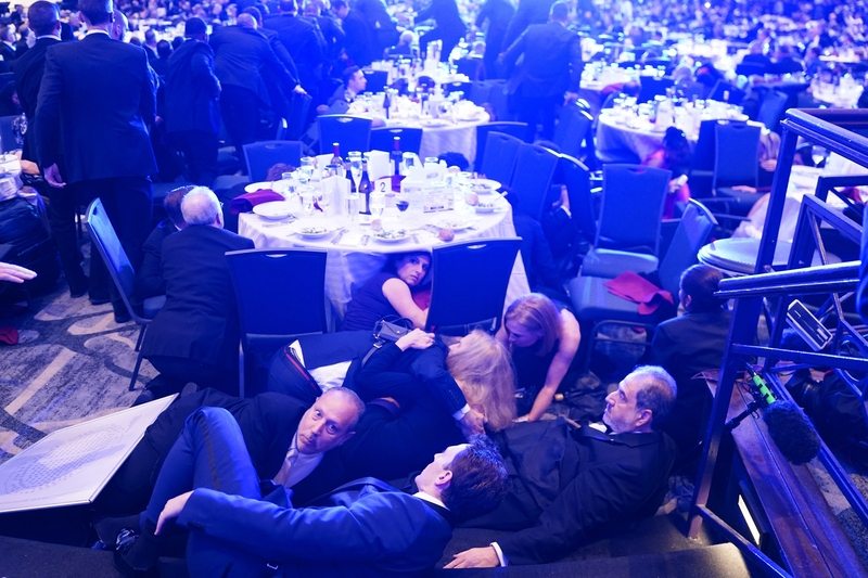 CEO of Strauss Media Richard Strauss, U.S. Rep. Jamie Raskin, D-Md., Kerry Kennedy, daughter of U.S. Health and Human Services Secretary Robert F. Kennedy Jr., Boston Globe DC Bureau Chief Jackie Kucinich,and D.C. Shadow Sen. Paul Strauss hide under tables after an incident at the annual White House Correspondents Association Dinner April 25, 2026 in Washington, D.C. (Photo by Nathan Howard/Getty Images)