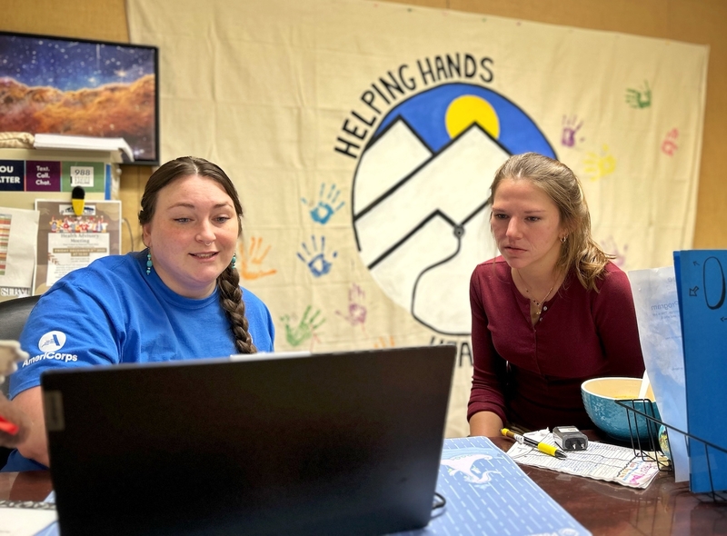 Lander Free Clinic staffers Audrey Zanetti and Stephanie Kohm go over volunteer schedules on Nov. 19, 2025. The clinic became a Certified Application Counselor Designated Organization this year to help patients navigate the Affordable Care Act marketplace. (Katie Klingsporn/WyoFile)