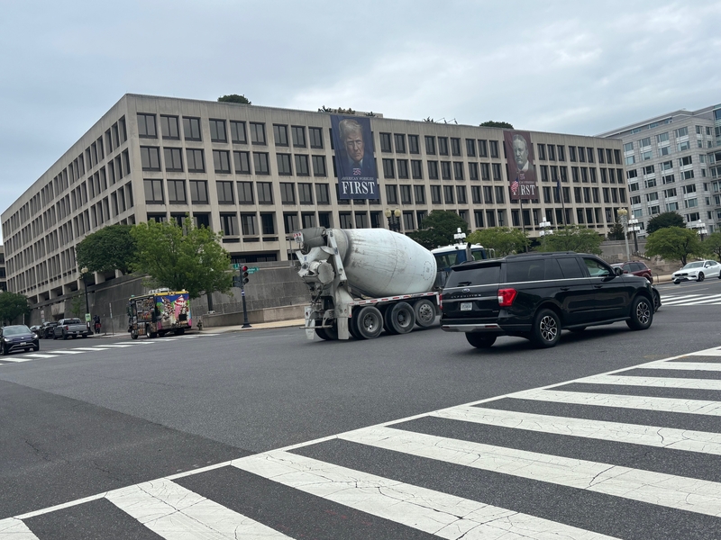 Traffic rumbles past a banner showing President Donald Trump hanging on the Department of Labor in Washington, D.C., on April 28, 2026. (Photo by David Lightman/States Newsroom)