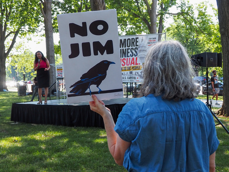 A protester listened to U.S. Rep. Analilia Mejia, D-N.J., at a rally on Capitol Hill on Wednesday, May 20, 2026, as the representative spoke against the recent U.S. Supreme Court decision to strike down part of the Voting Rights Act. (Photo by Ashley Murray/States Newsroom)