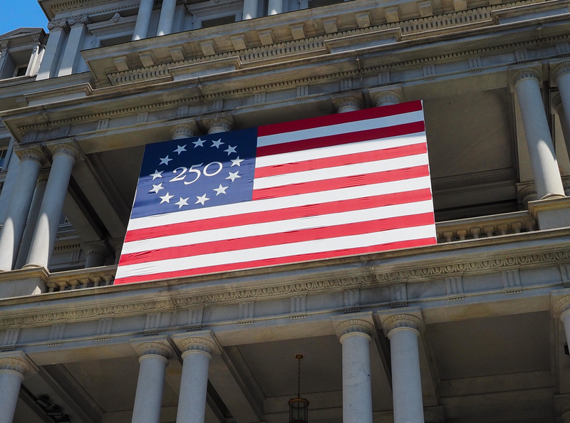 A 250th anniversary flag on the Dwight D. Eisenhower Executive Office Building, location of the vice president’s office, on 17th Street NW in Washington, D.C., on Tuesday, May 5, 2026. (Photo by Ashley Murray/States Newsroom)
