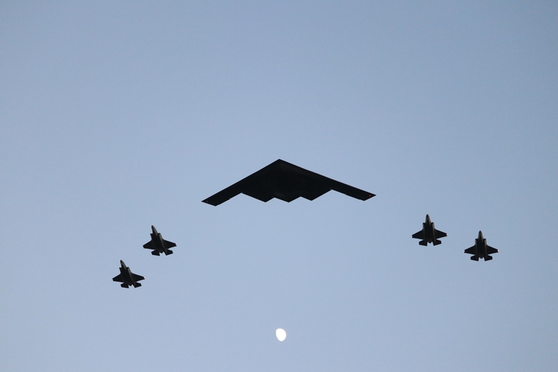 A B-2 stealth bomber accompanied by four fighter jets performs a flyover at the Freedom 250 kickoff on the National Mall on June 24, 2026. (Sam Gauntt/States Newsroom)