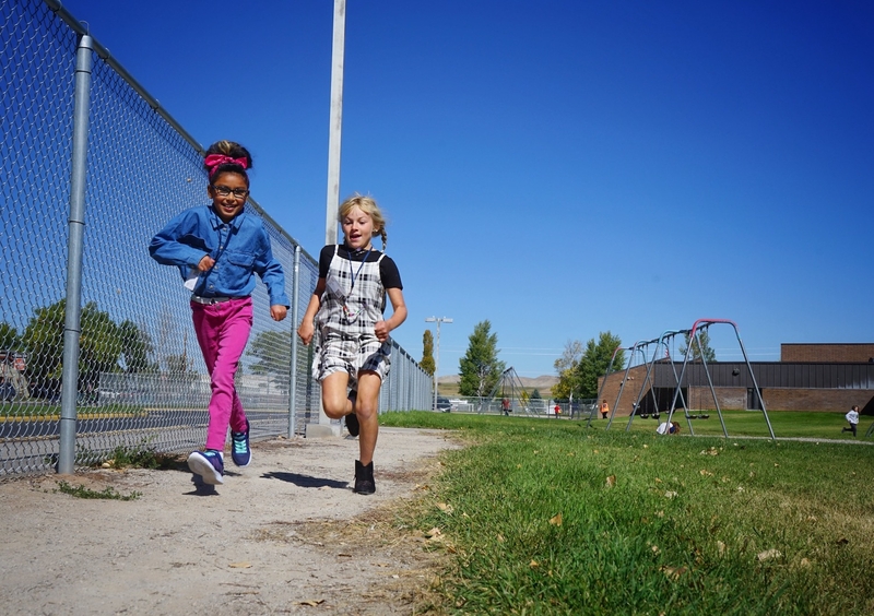 Fourth graders Kylah Thunder and Shayla McNair run a recess lap at Baldwin Creek Elementary School in Lander on Sept. 26, 2023. (Katie Klingsporn/WyoFile)