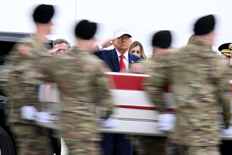 President Donald Trump salutes as a U.S. Army carry team moves a flag-draped transfer case containing the remains of Sgt. Declan J. Coady at Dover Air Force Base on March 07, 2026 in Dover, Delaware. Six soldiers from the 103rd Sustainment Command were killed in action by an Iranian drone strike on March 1 in Port Shuaiba, Kuwait during "Operation Epic Fury". (Photo by Roberto Schmidt/Getty Images)