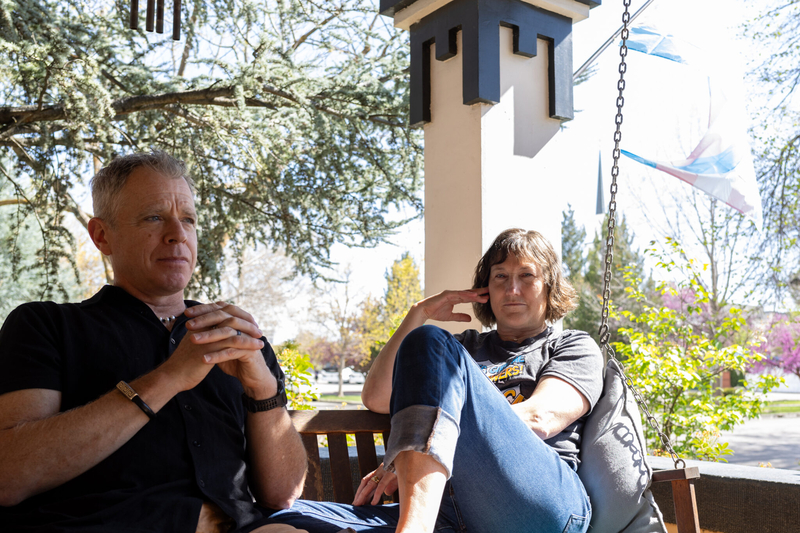 Michael and Dr. Angie Devitt sit in front of their home relecting.