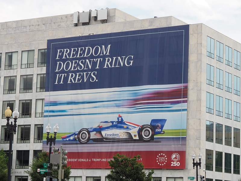A banner promoting the Freedom 250 Grand Prix scheduled for August hangs on the Department of Transportation's Orville Wright Federal Building at 800 Independence Ave. SW on Monday, June 22, 2026. (Photo by Ashley Murray/States Newsroom)