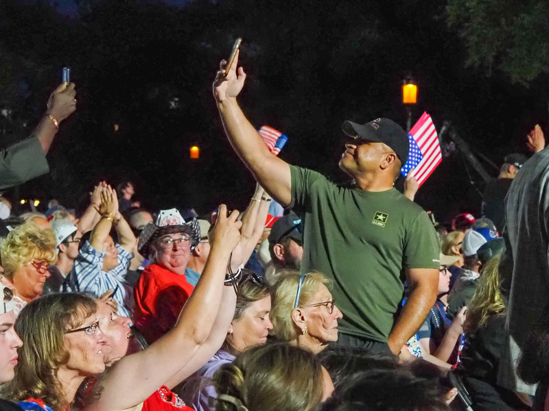 A man in the crowd wearing a U.S. Army shirt takes a selfie as President Donald Trump spoke Wednesday, June 24, 2026, for the administration's Freedom 250 kickoff event. (Photo by Ashley Murray/States Newsroom)
