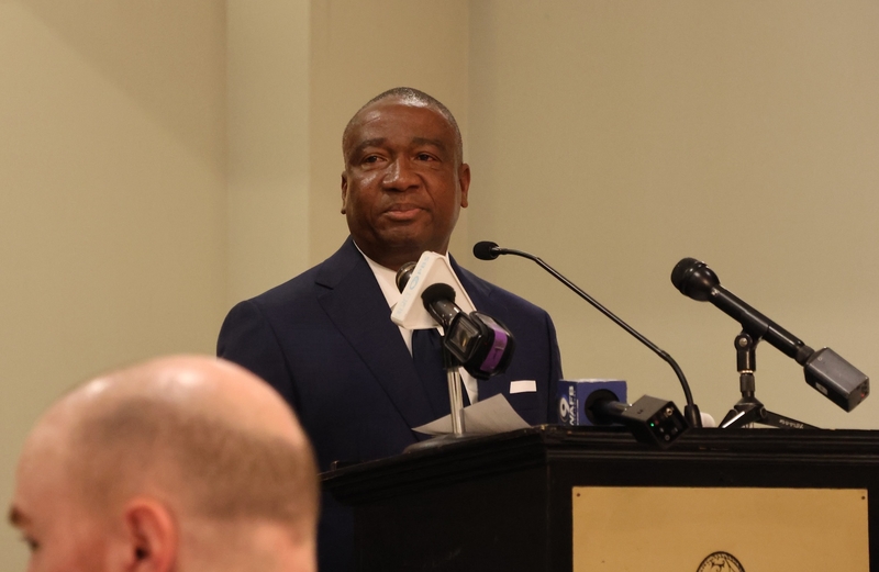 Representative Cleo Fields stands in front of a podium at a conference.