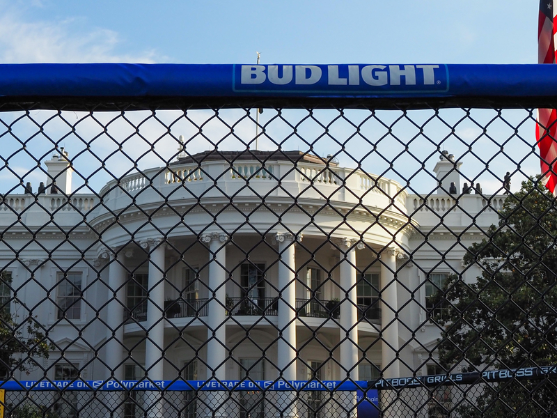 Various advertisements, including those for Bud Light beer and Polymarket live betting, surrounded the Ultimate Fighting Championship ring, or "octagon," on the White House South Lawn on Thursday, June 11, 2026. (Photo by Ashley Murray/States Newsroom)