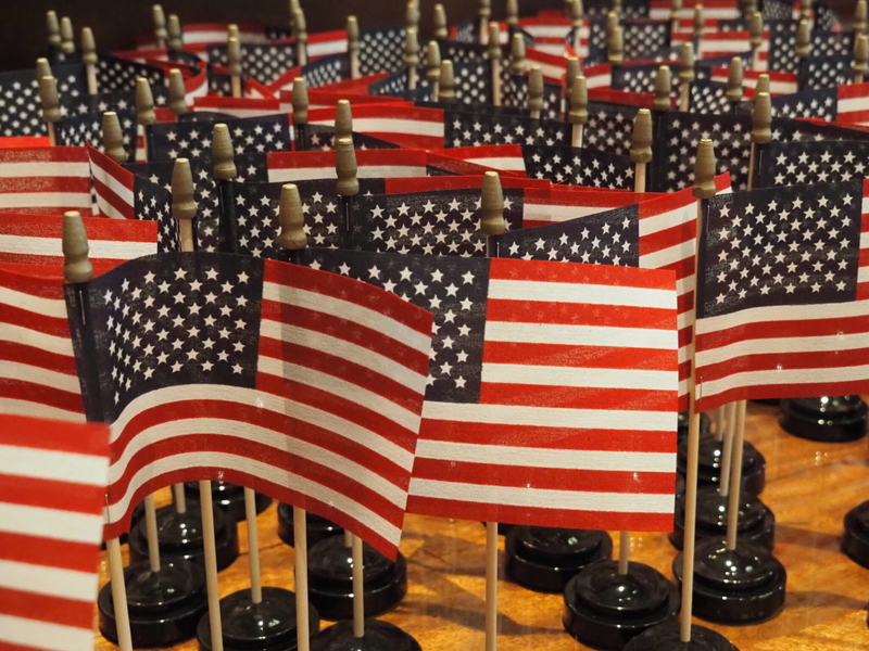American flags sit on a table a wooden table before a naturalization ceremony at the federal courthouse in downtown Indianapolis