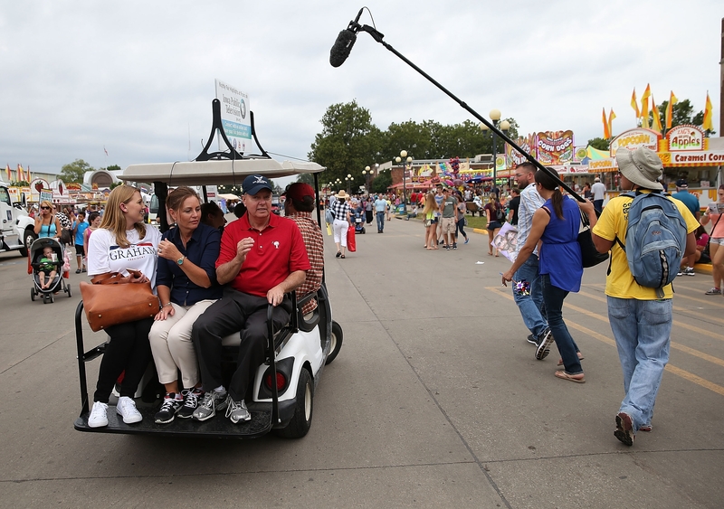 The late Sen. Lindsey Graham, R-S.C., right, at the time a candidate for president, rides on the back of a golf cart with his sister Darlin