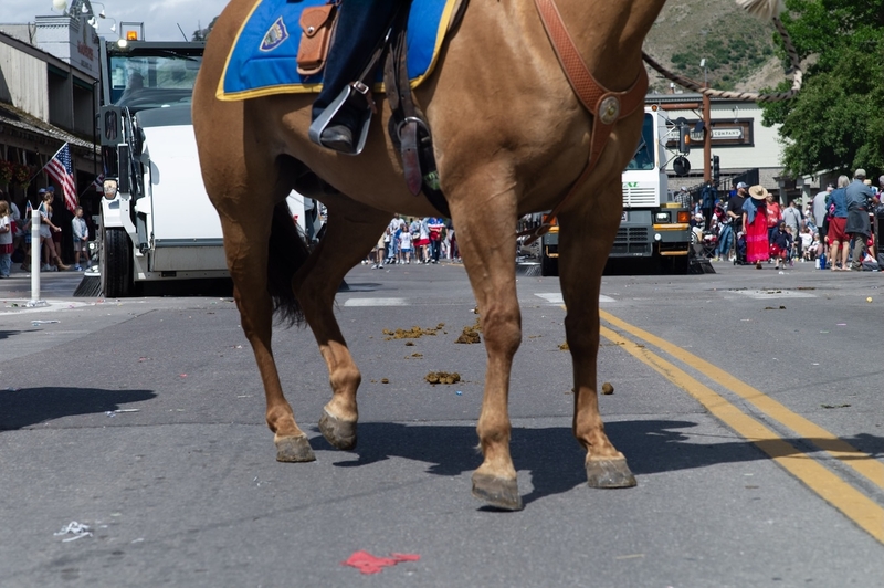 At the end of the 2025 July 4 parade in Jackson, street sweepers move in to do their important job. (Angus M,. Thuermer Jr./WyoFile)