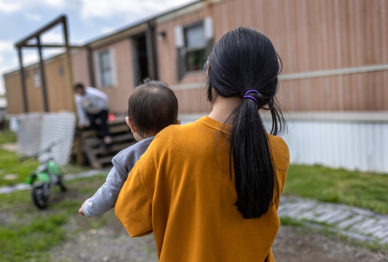 SELLERSBURG, INDIANA - APRIL 25: Honduran immigrant Nani, 10, carries her baby cousin after moving in with her extended family on April 25, 2021 in Sellersburg, Indiana. She had been released two days before from U.S. Health and Human Services (HHS) custody as an unaccompanied minor after spending nearly eight weeks in shelters, the last one in New York City. Originally Nani had traveled with her mother from Honduras and crossed the Rio Grande from Mexico together, but they were immediately deported under T