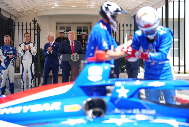 President Donald Trump speaks as (L-R) 2026 Indianapolis 500 winner Felix Rosenqvist, reigning IndyCar series champion Alex Palou and Freedom 250 Grand Prix Chairman Bud Denker look on at a Freedom 250 Grand Prix showcase on West Executive Avenue between the West Wing of the White House and the Eisenhower Executive Office Building on July 13, 2026 in Washington, DC. The IndyCar Freedom 250 Grand Prix car race, August 22 and 23 on the National Mall, is part of America's 250th anniversary celebrations. (Photo