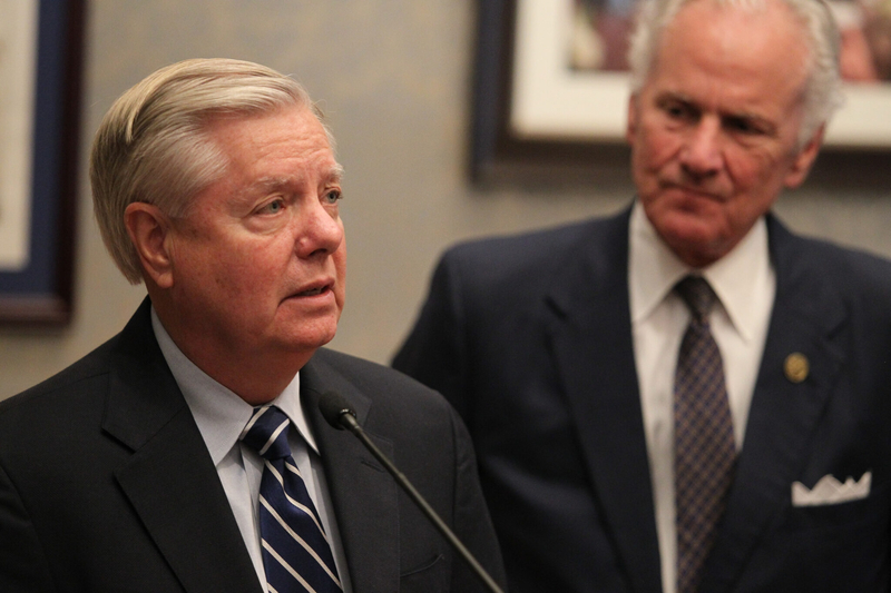 U.S. Sen. Lindsey Graham speaks as S.C. Gov. Henry McMaster looks on during a press conference in the governor’s office at the Statehouse in Columbia, South Carolina, on Aug. 9, 2022. (File photo by Travis Bell/STATEHOUSE CAROLINA/Special to the SC Daily Gazette)