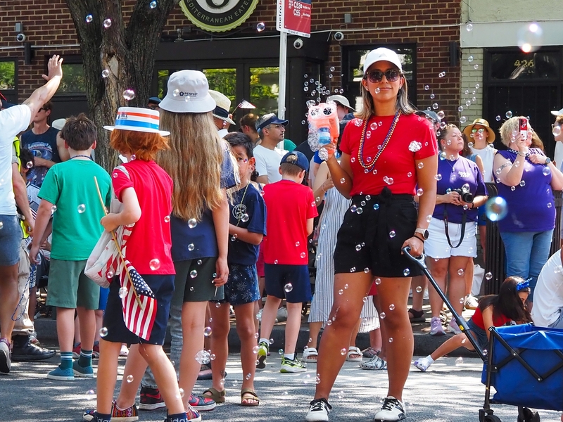 A woman marching in the Capitol Hill Fourth of July Parade in Washington, D.C., blew bubbles on Saturday, July 4, 2026. (Photo by Ashley Murray/States Newsroom)