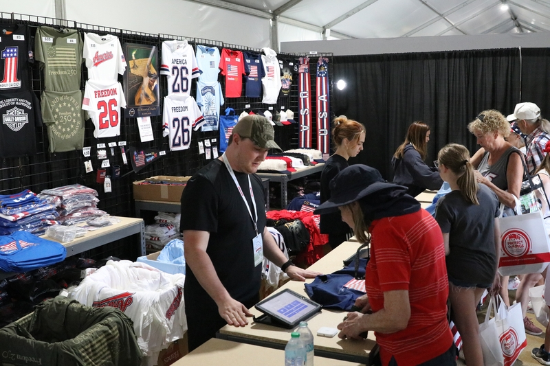 Merchandise tied to America’s 250th birthday is sold in a stall at Freedom 250’s Great American State Fair in Washington, D.C., on June 30, 2026. (Photo by Sam Gauntt/States Newsroom)