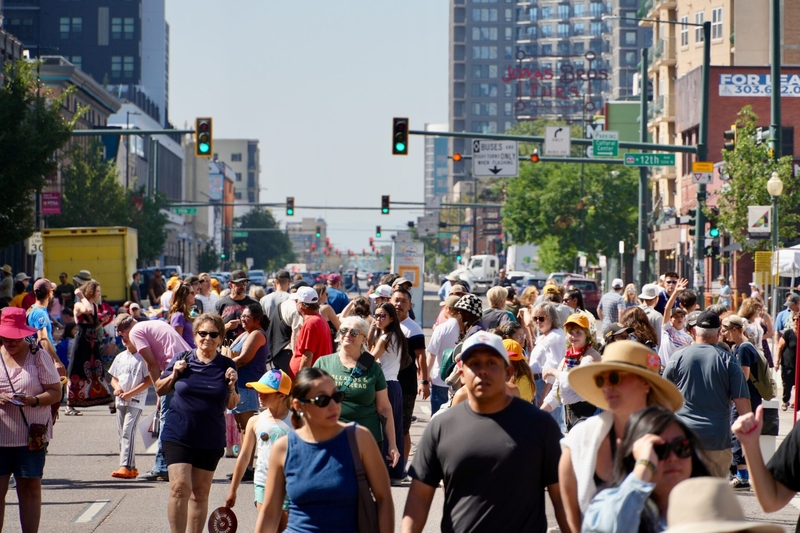 People walk through a festival in Colorado