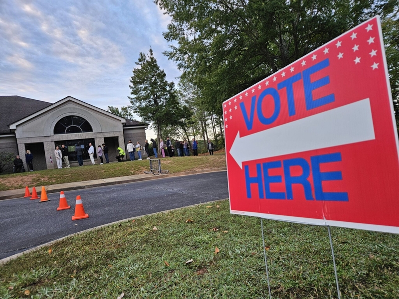 Georgia voters stand outside in line at their polling place in 2024