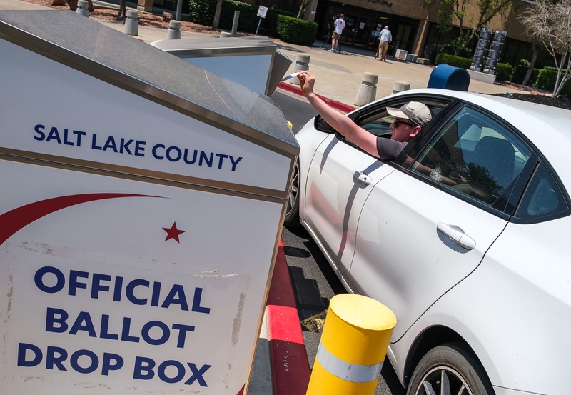 A voter drops off a ballot on primary Election Day at the Salt Lake County Government Center on Tuesday, June 23, 2026. (Photo by Marco Lozzi for Utah News Dispatch)
