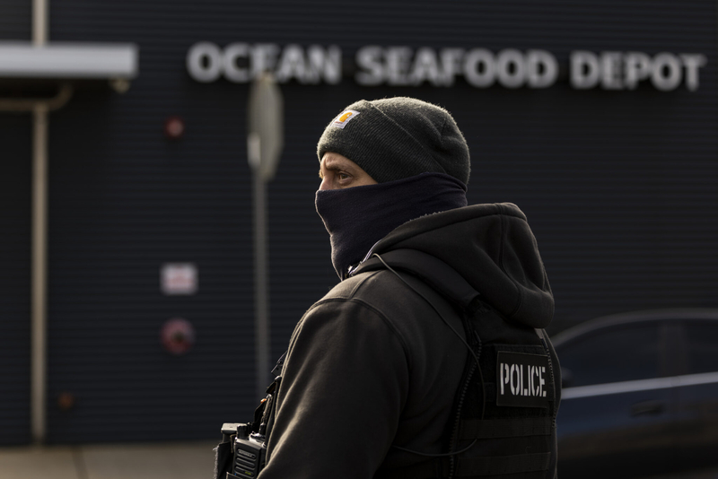 A masked, armed agent outside Ocean Seafood Depot during an immigration raid, Newark, NJ, Wednesday, Nov. 19, 2025. (Photo by Anne-Marie Caruso/New Jersey Monitor)