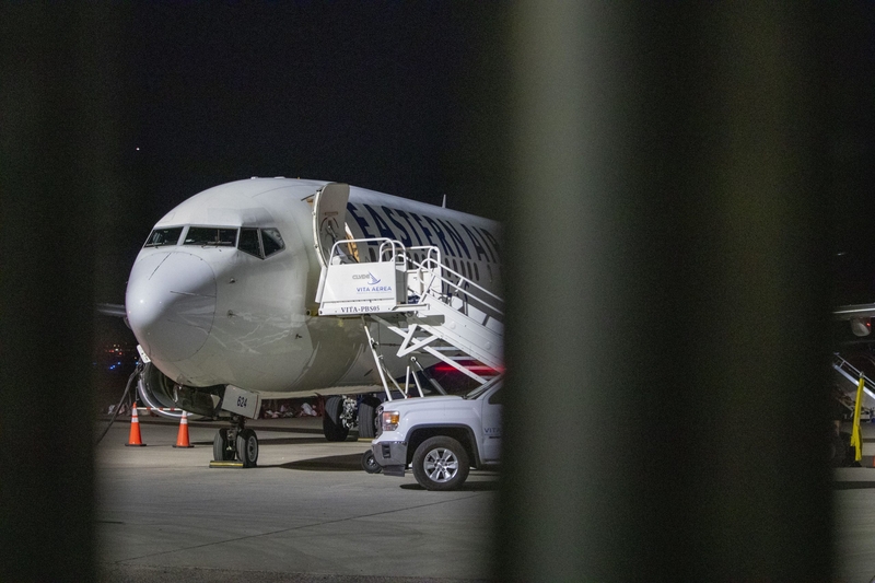 An airplane sits on the tarmac at Mesa Gateway Airport on the evening of April 9, 2026, outside of the Arizona Removal Operations Coordination Center, an ICE facility where detainees are temporarily housed before they are put on a plane to either be deported or moved to a different ICE facility. (Photo by Jerod MacDonald-Evoy/Arizona Mirror)