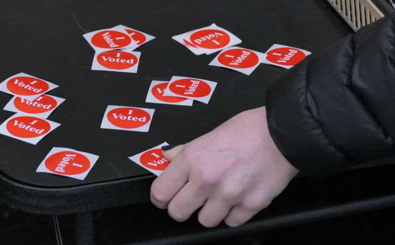 A voter takes an "I Voted" sticker at the Brackett Recreation Center in Minneapolis on Nov. 2, 2021. (Photo by Max Nesterak/Minnesota Reformer)