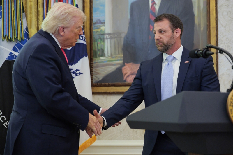 President Donald Trump shakes hands with newly sworn in Department of Homeland Security Secretary Markwayne Mullin during a ceremony in the Oval Office at the White House on March 24, 2026 in Washington, DC. (Photo by Chip Somodevilla/Getty Images)