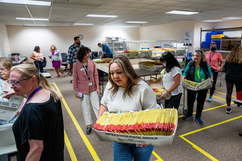 Election worker Davina Trejo carries a box of ballots to her work station at the Salt Lake County Government Center in Salt Lake City as votes are cast in Utah’s primary election on June 25, 2024. (Photo by Spenser Heaps for Utah News Dispatch