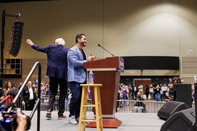 Michigan U.S. Senate candidate Abdul El-Sayed, right, speaks at a rally with U.S. Sen. Bernie Sanders, left, U.S. Rep. Alexandria Ocasio-Cortez and U.S. House candidate William Lawrence in Lansing, Michigan, on July 19, 2026. (Photo by Andrew Roth/Michigan Advance)
