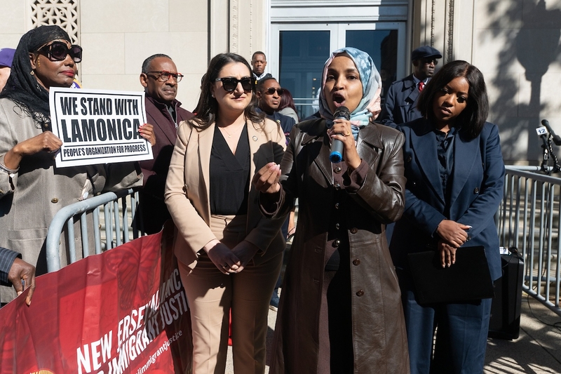 Democratic U.S. Rep. Ilhan Omar of Minnesota speaks during a rally in support of Rep. LaMonica McIver, D-N.J., outside a federal courthouse in Newark, New Jersey, on Oct. 21, 2025. She is flanked by Democratic Reps. Sara Jacobs of California, left, and Jasmine Crockett of Texas, right. (Photo by Reena Rose Sibayan/New Jersey Monitor)