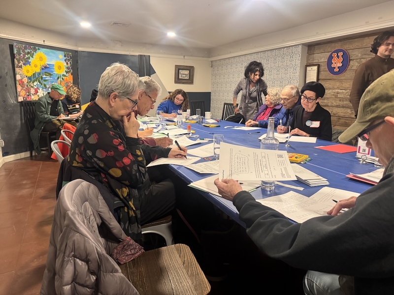 In the Jackson Heights neighborhood of Queens, New York, a chapter of Indivisible, one of the grassroots organizations behind No Kings, brought together volunteers to write letters to voters in battleground states, encouraging them to get out and vote as early as possible. (Photo by Shalina Chatlani/Stateline)