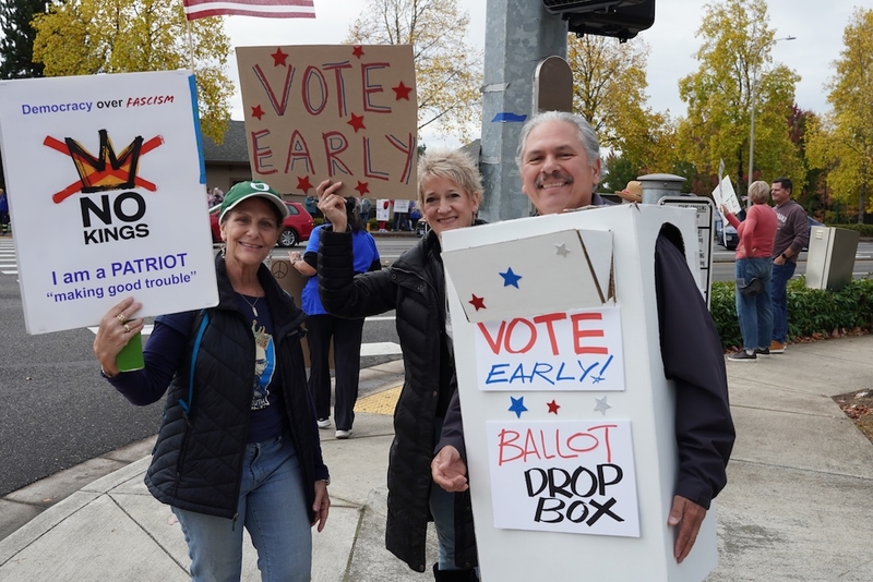 Oregon Democratic state Sen. Mark Meek, who is up for reelection and dressed as a ballot box, joined demonstrators in Happy Valley on Saturday for a No Kings event to encourage early voting. “Us out here today is just representative that we care about our country, we love our country, and nobody can tell us that we’re less American than anybody else. We want proper elected officials representing this country, and the only way we can change it is to vote.” (Photo by Shaanth Nanguneri/Oregon Capital Chronicle