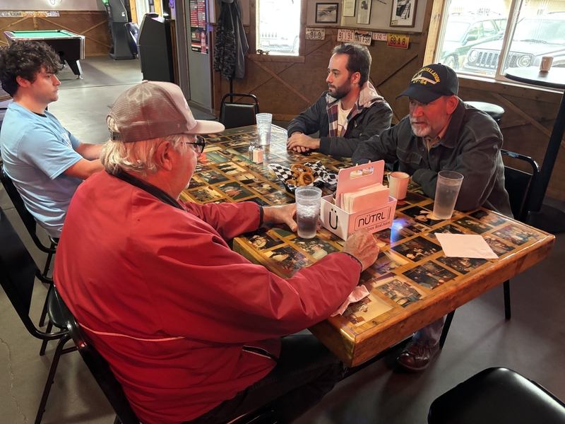 Independent U.S. Senate candidate Dan Osborn, front right, speaks with Ray Cerny, front left, during a stop at a local restaurant in Arthur, Nebraska, on Oct. 15, 2026. (Photo by Jonathan Shorman/States Newsroom)