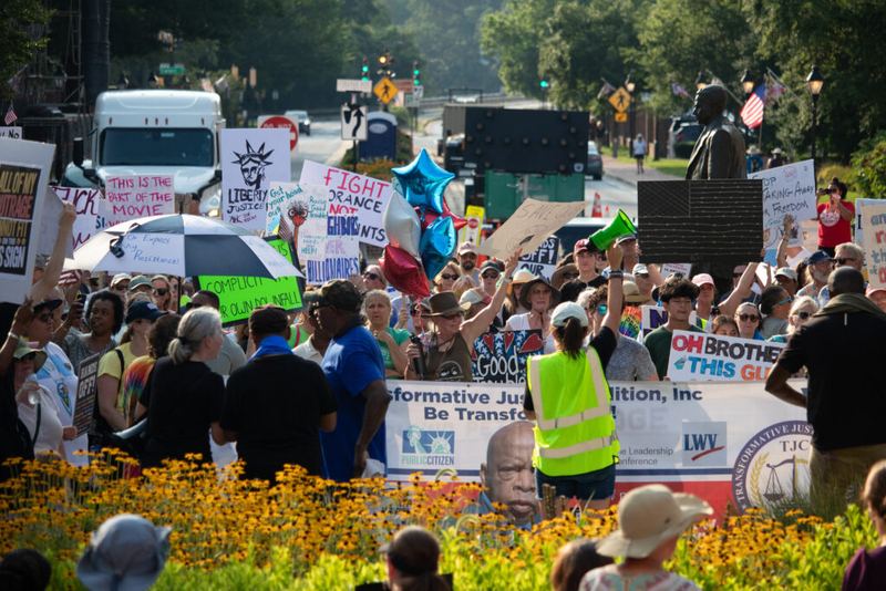 Hundreds bring ‘good trouble’ rally to State House steps