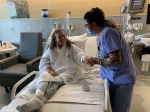 Campbell County Health CNA Gemma Monthey helps patient Maria Diaz on June 22, 2020. (Dustin Bleizeffer/WyoFile)