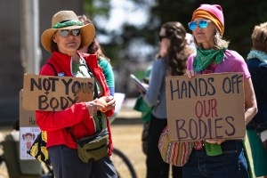 Maryalice Snider and Ann Acuff stand in protest outside the Wyoming Supreme Court before the court hears the appeal of a district court abortion decision on Wednesday, April 16, 2025, in Cheyenne. (Milo Gladstein/Wyoming Tribune Eagle)