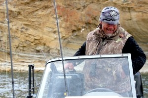 Robb Keith laughs while fishing for puppy lake trout on Flaming Gorge Reservoir, a pursuit that’s a personal passion. The Green River resident supervised the fishery for the Wyoming Game and Fish Department for a quarter century before retiring in 2025. (Mike Koshmrl/WyoFile)
