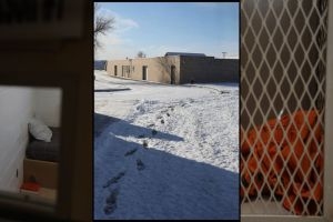 From left, a journal sits next to the bed of a student inside his dorm room on Dec. 10, 2021 at the Wyoming Boys' School in Worland. Footprints in the snow lead to the Wyoming Boys' School. A uniform lays in the bottom of a locker. Orange jumpsuits are for students who are new or considered high-risk. (Lauren Miller/Casper Star-Tribune)