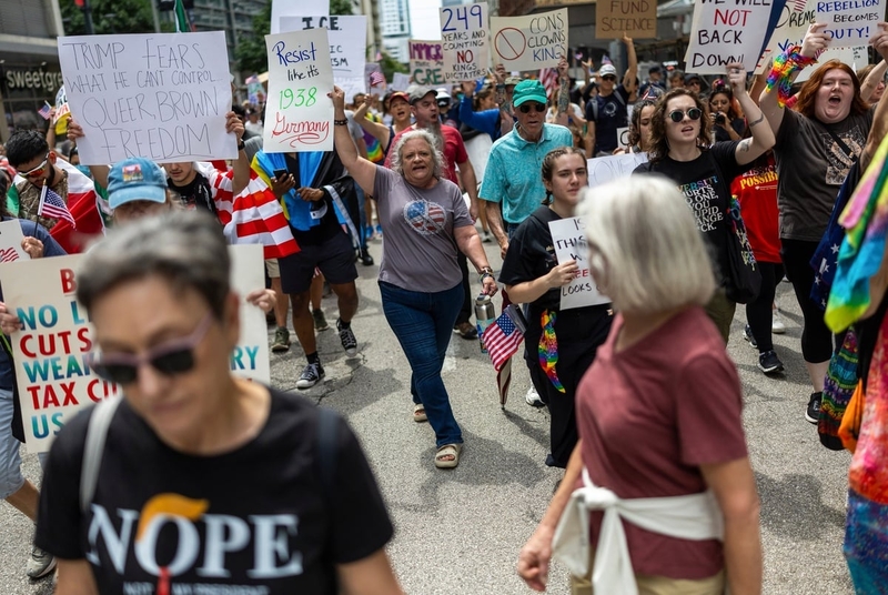 As Trump celebrates military, Texans protest president’s aggressive immigration enforcement