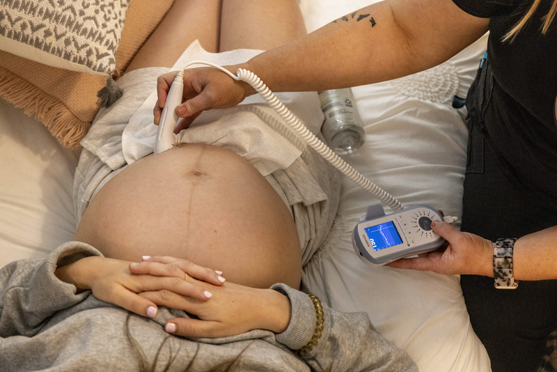 Midwife Amanda Smith uses a handheld doppler device to check the baby’s heartbeat during a prenatal visit with Haley Herrington in Hattiesburg, Miss., in May 2023. Credit: Eric Shelton/Mississippi Today