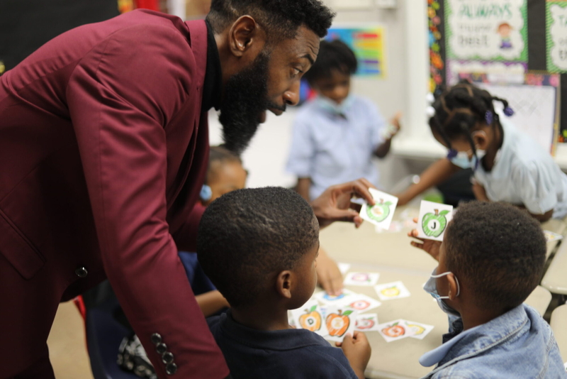 Taurean Morton, state director of Reading Roadmap, helps students practice sounding out the first letter in a word during the afterschool literacy program in the Mississippi Delta, Oct. 10, 2023. Credit: Julia James/Mississippi Today